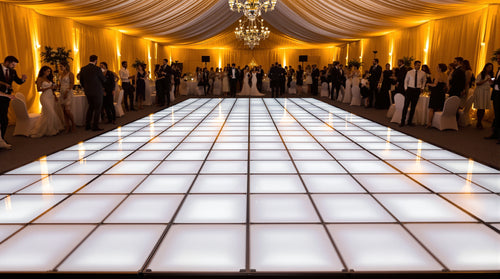 10x14 LED dance floor, 5x7 tile grid of 2ft panels, glowing gold and white in a long tented reception