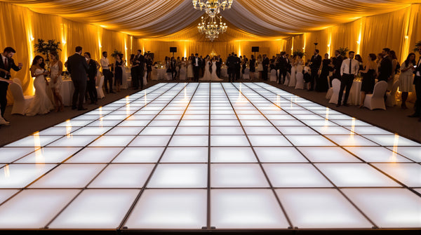 10x14 LED dance floor, 5x7 tile grid of 2ft panels, glowing gold and white in a long tented reception